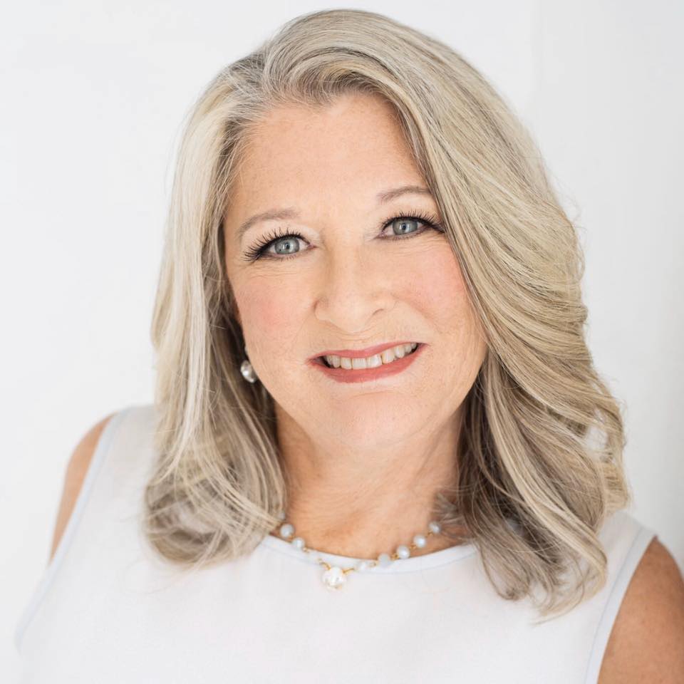 Donna Melton Mississippi Gulf Coast Realtor smiling in white dress while providing trusted real estate guidance for home buyers and sellers along the Mississippi Gulf Coast.